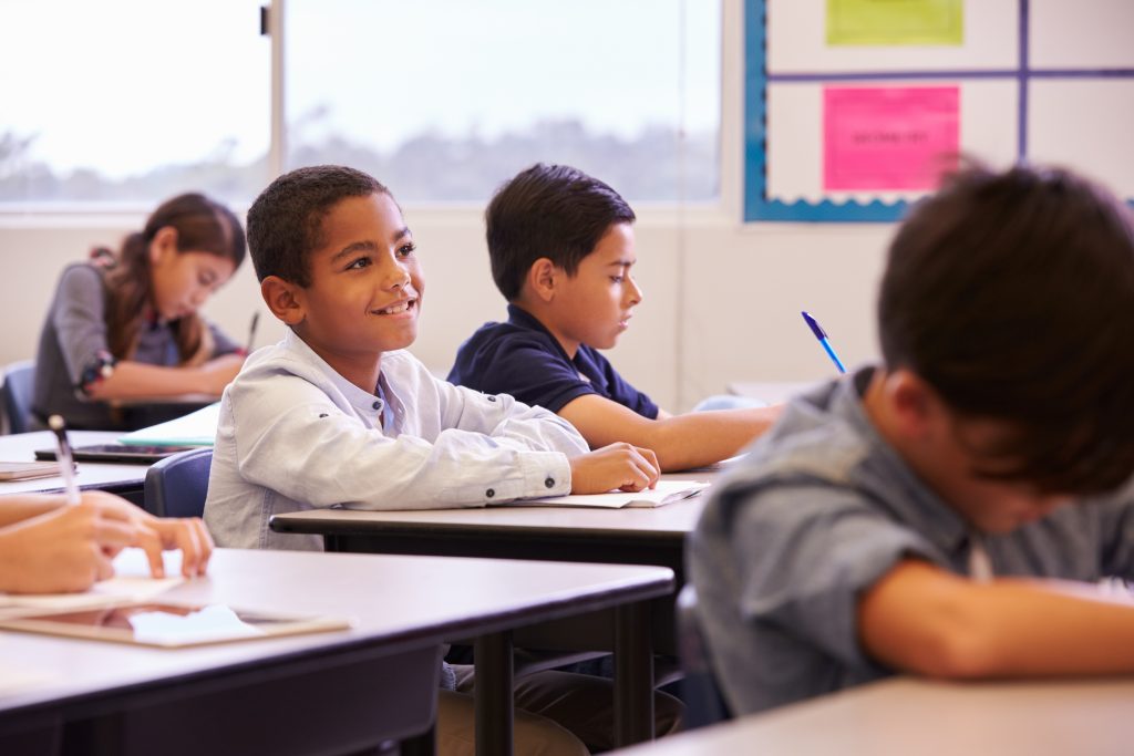 Elementary,School,Kids,Working,At,Their,Desks,In,A,Classroom